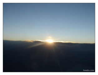 Sun rises at the horizon